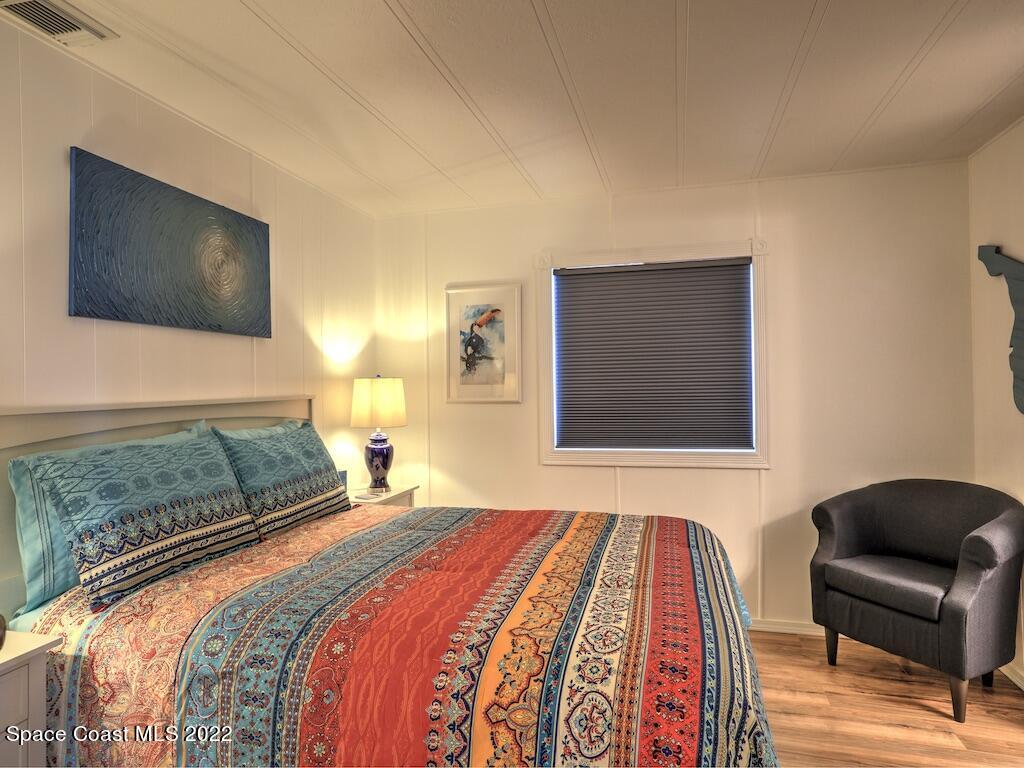 727 Periwinkle Drive Sebastian, FL 32976 - Photo 24 of 34 a bedroom with a bed and a television