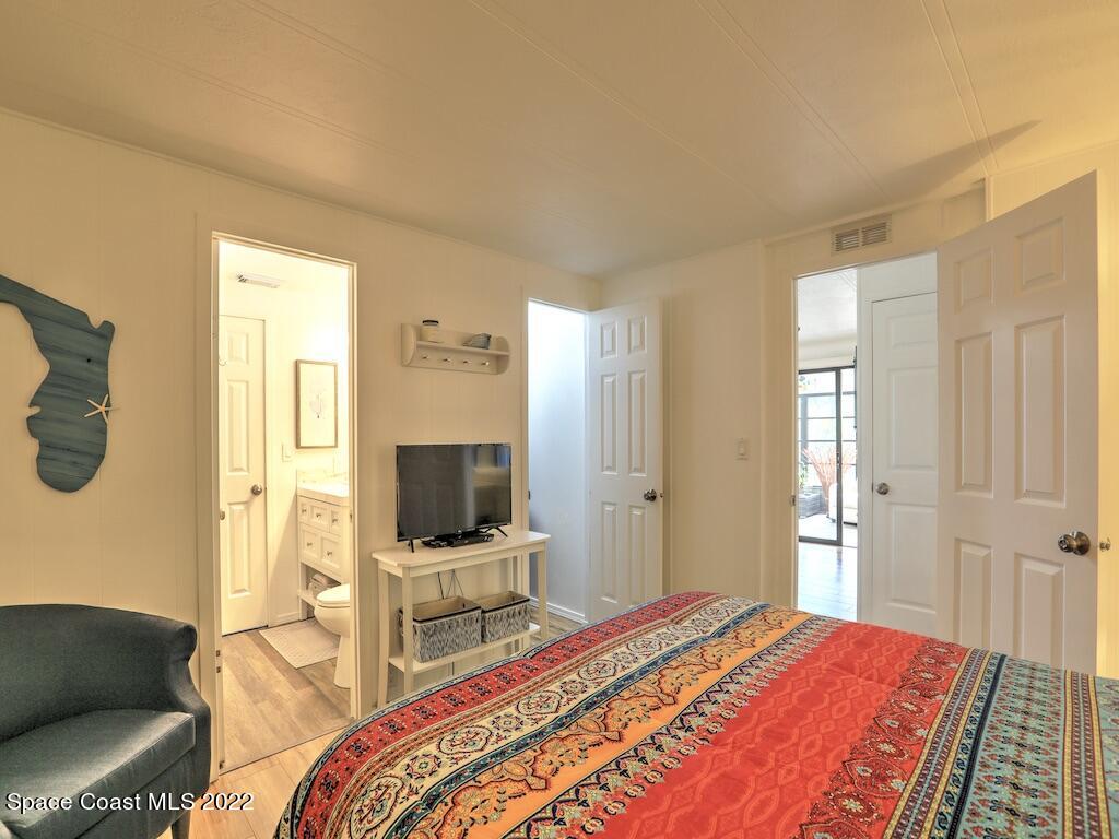 727 Periwinkle Drive Sebastian, FL 32976 - Photo 25 of 34 a bedroom with a bed and a flat screen tv