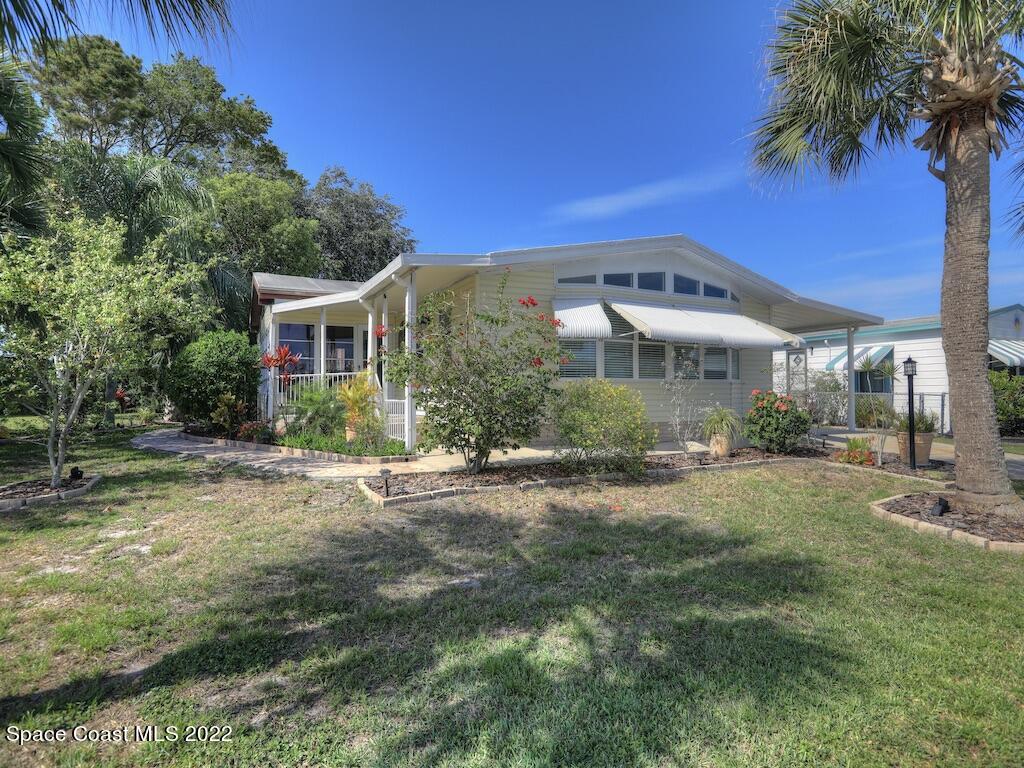 727 Periwinkle Drive Sebastian, FL 32976 - Photo 3 of 34 a view of a house with a yard and potted plants