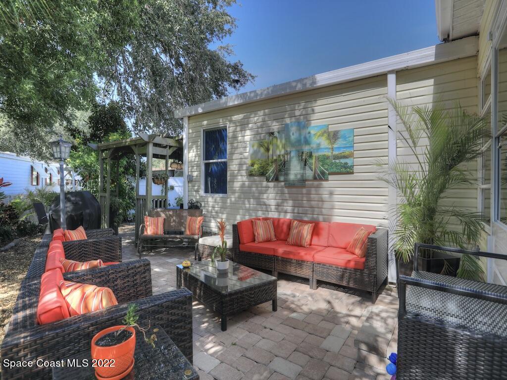 727 Periwinkle Drive Sebastian, FL 32976 - Photo 5 of 34 an outdoor sitting area with furniture and wooden floor