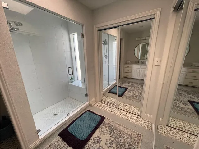 a bathroom with a glass shower door