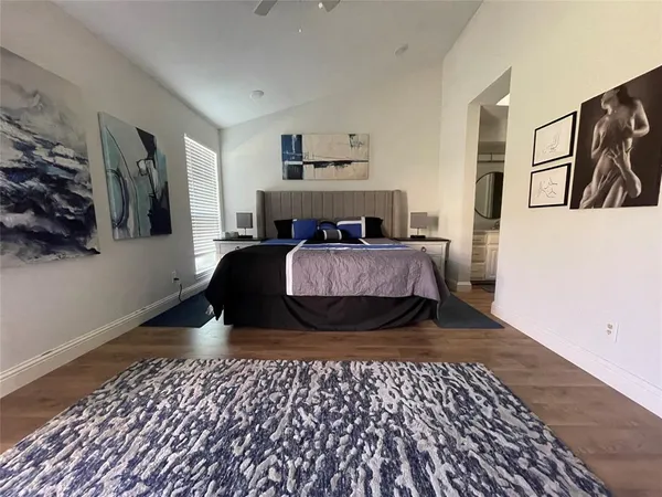 a bedroom with double bed and a window