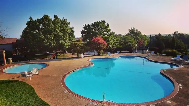 a view of a swimming pool with an outdoor space and seating area