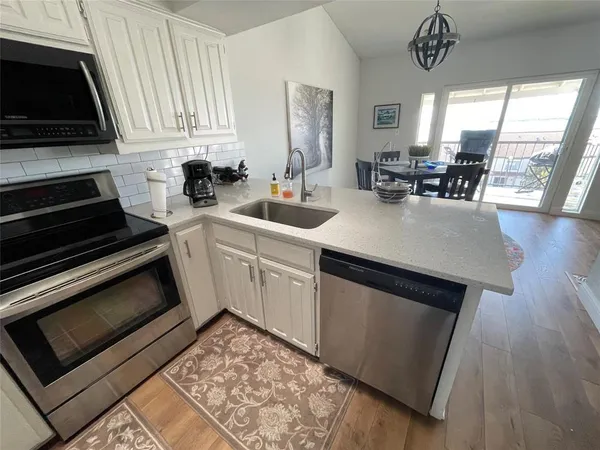 a kitchen with a sink stove and cabinets