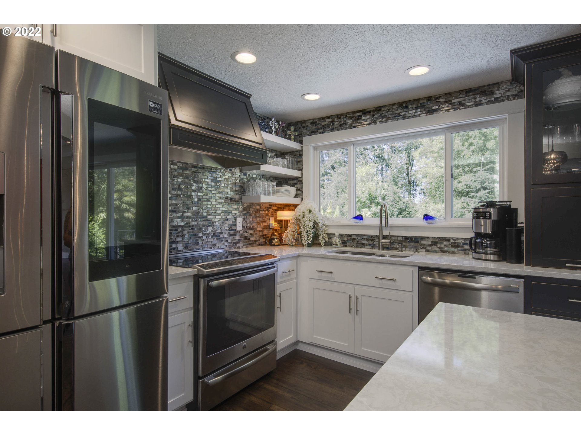 10419 Crosby Road Northeast Woodburn, OR 97071 - Photo 12 of 32 a kitchen with stainless steel appliances granite countertop a refrigerator and a sink