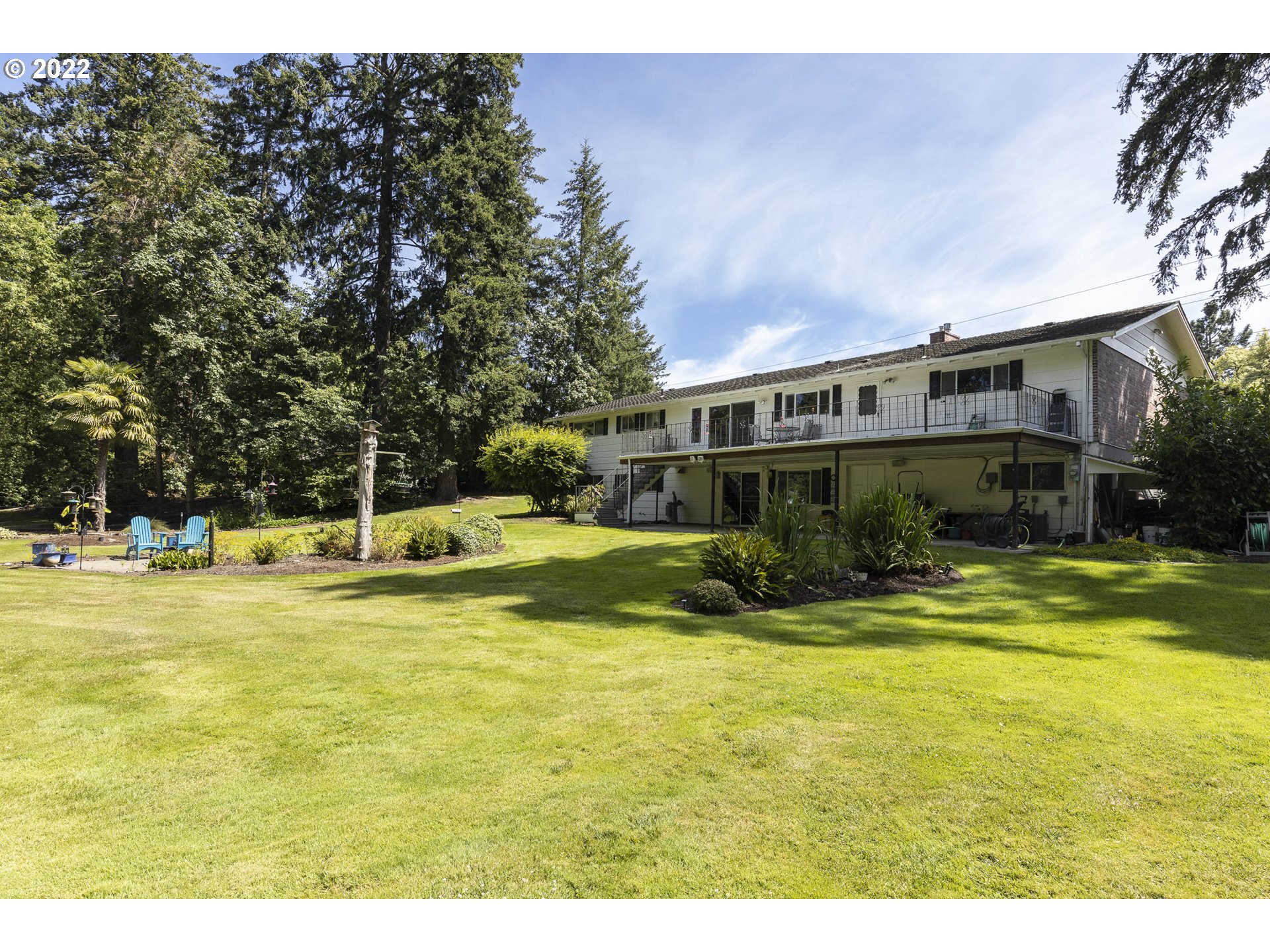 10419 Crosby Road Northeast Woodburn, OR 97071 - Photo 26 of 32 a view of a swimming pool with lawn chairs and plants