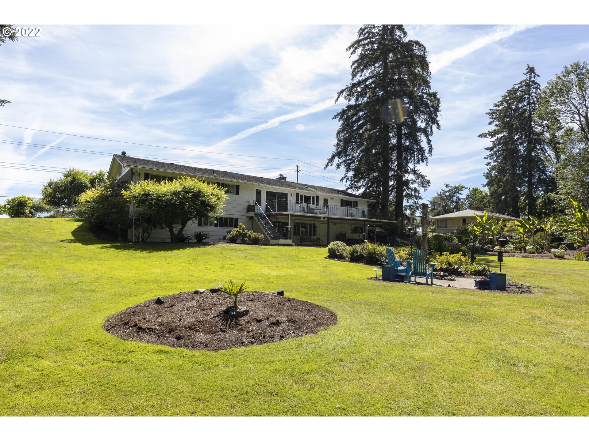 10419 Crosby Road Northeast Woodburn, OR 97071 - Photo 27 of 32 a view of swimming pool with outdoor seating and trees in the background