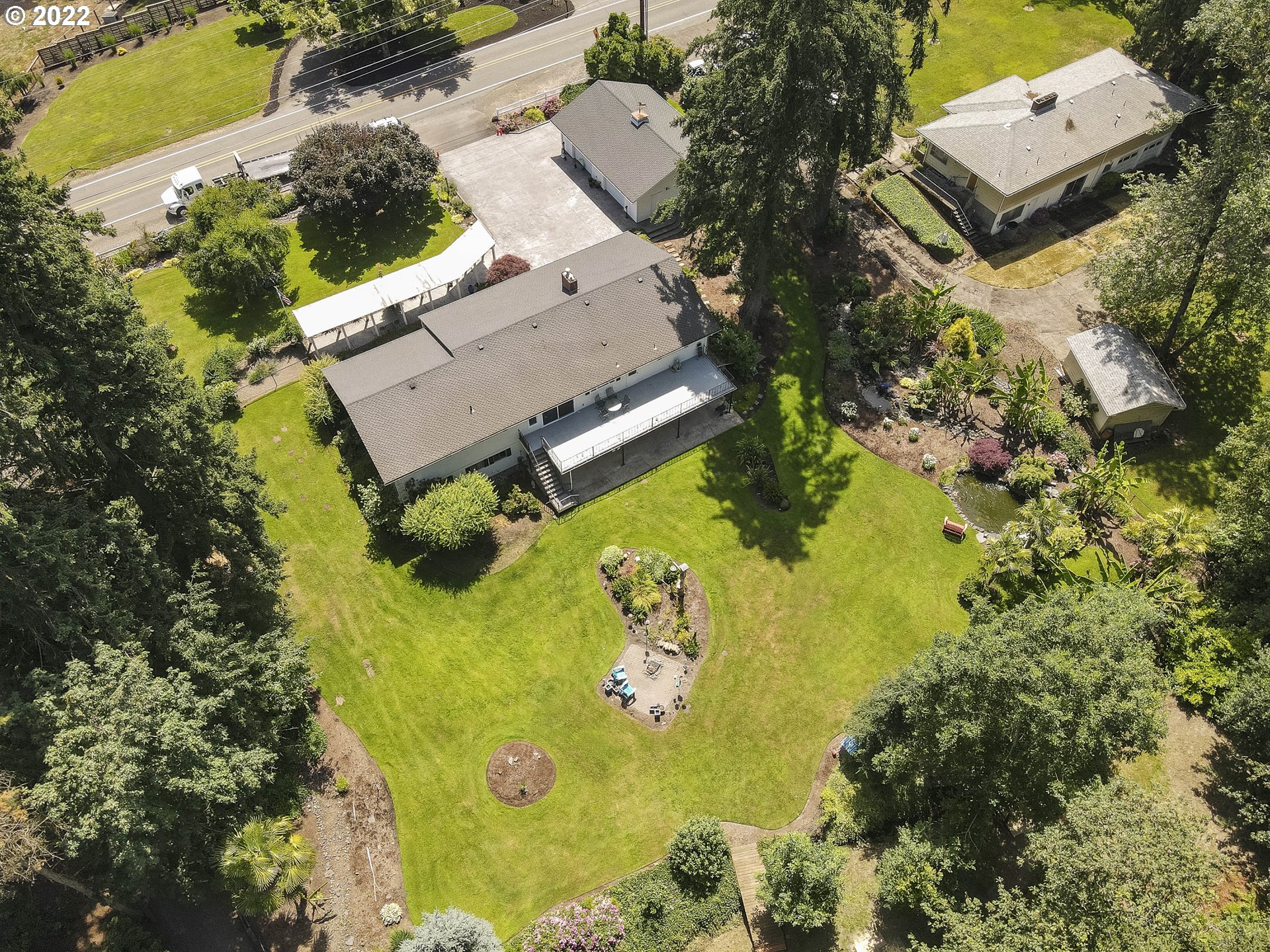 10419 Crosby Road Northeast Woodburn, OR 97071 - Photo 32 of 32 an aerial view of a house with swimming pool and large trees