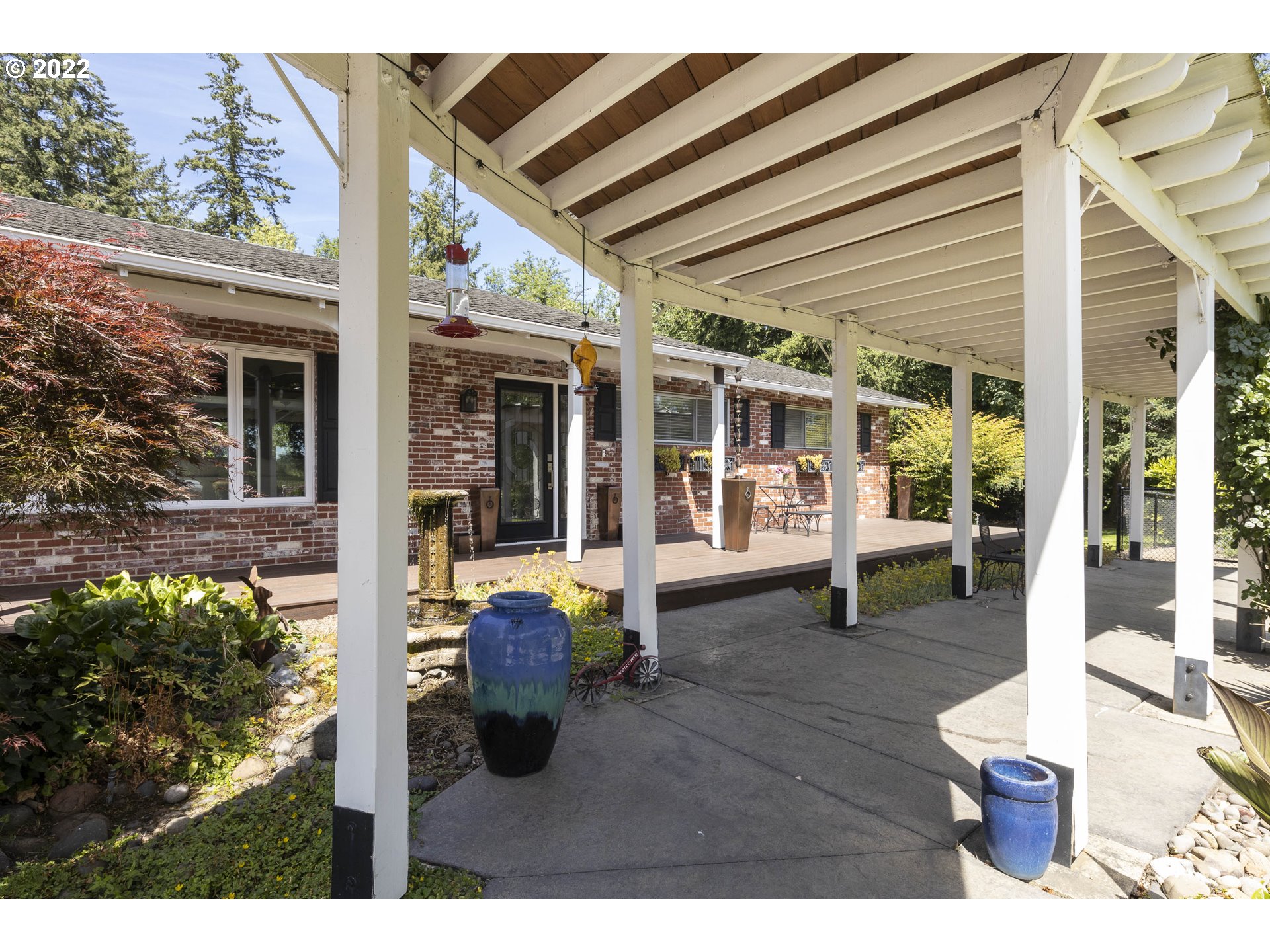10419 Crosby Road Northeast Woodburn, OR 97071 - Photo 4 of 32 a view of a patio with table and chairs and potted plants