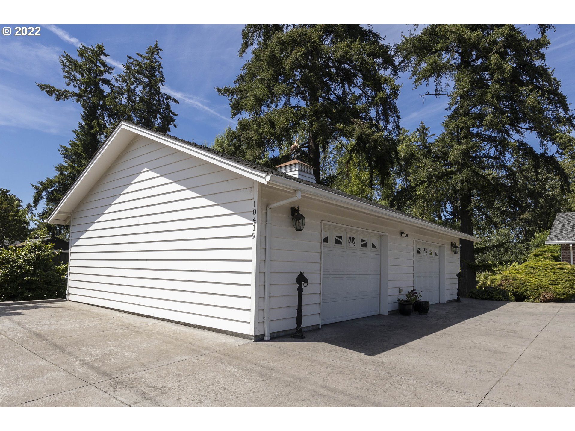 10419 Crosby Road Northeast Woodburn, OR 97071 - Photo 5 of 32 a view of a white house with a yard and potted plants
