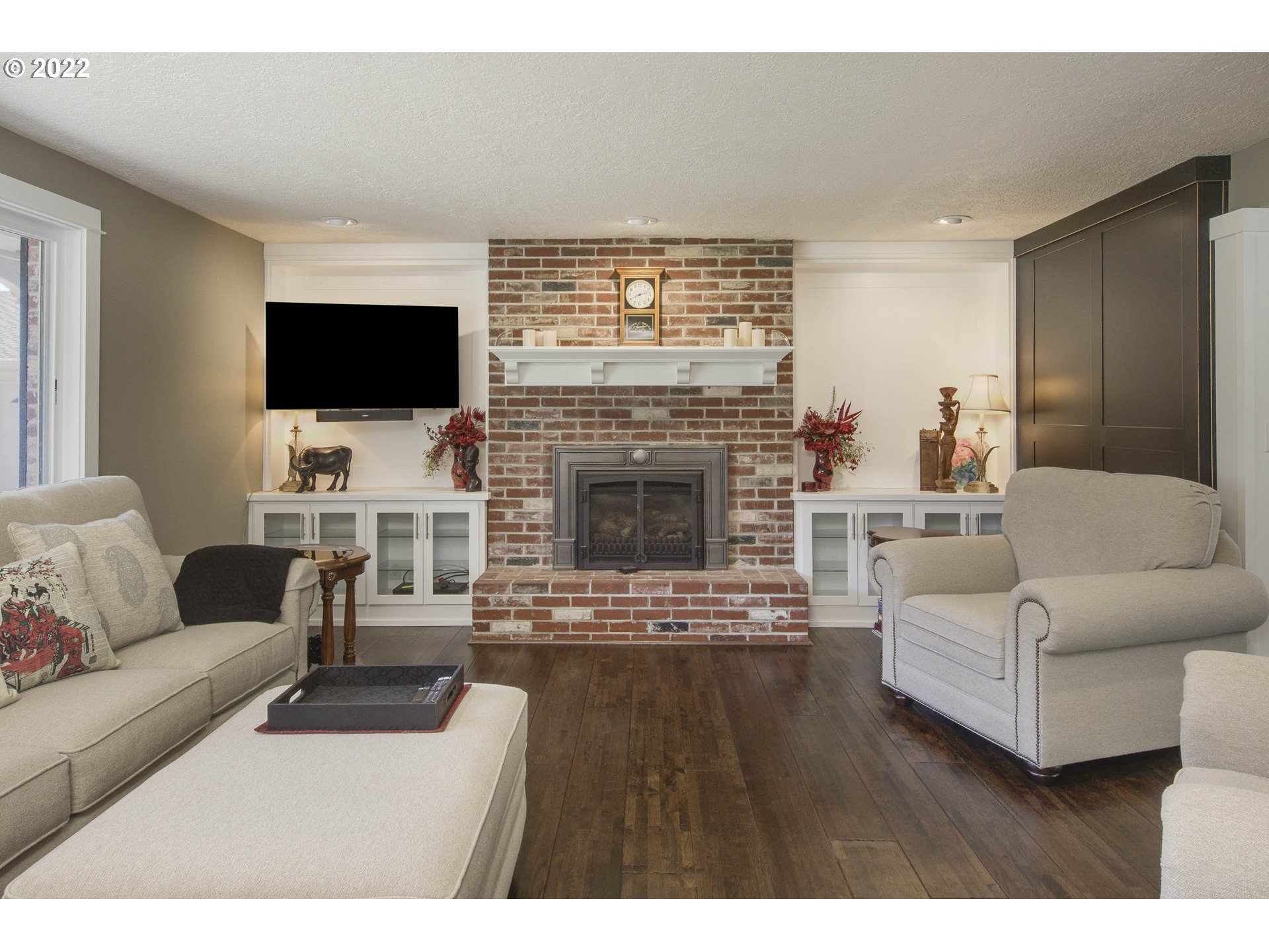 10419 Crosby Road Northeast Woodburn, OR 97071 - Photo 6 of 32 a living room with furniture a flat screen tv and a fireplace