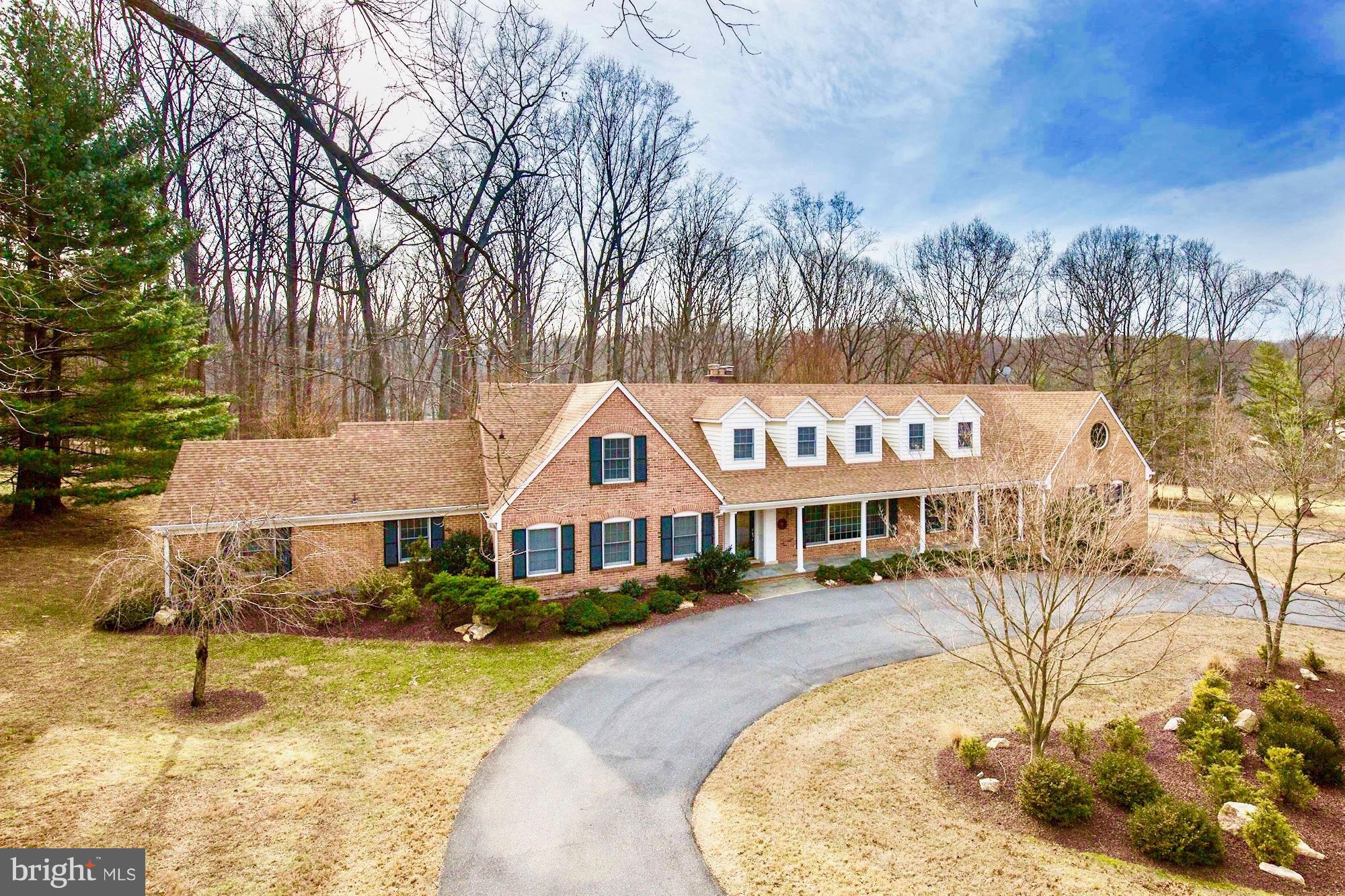 a view of swimming pool with outdoor seating and trees in the background