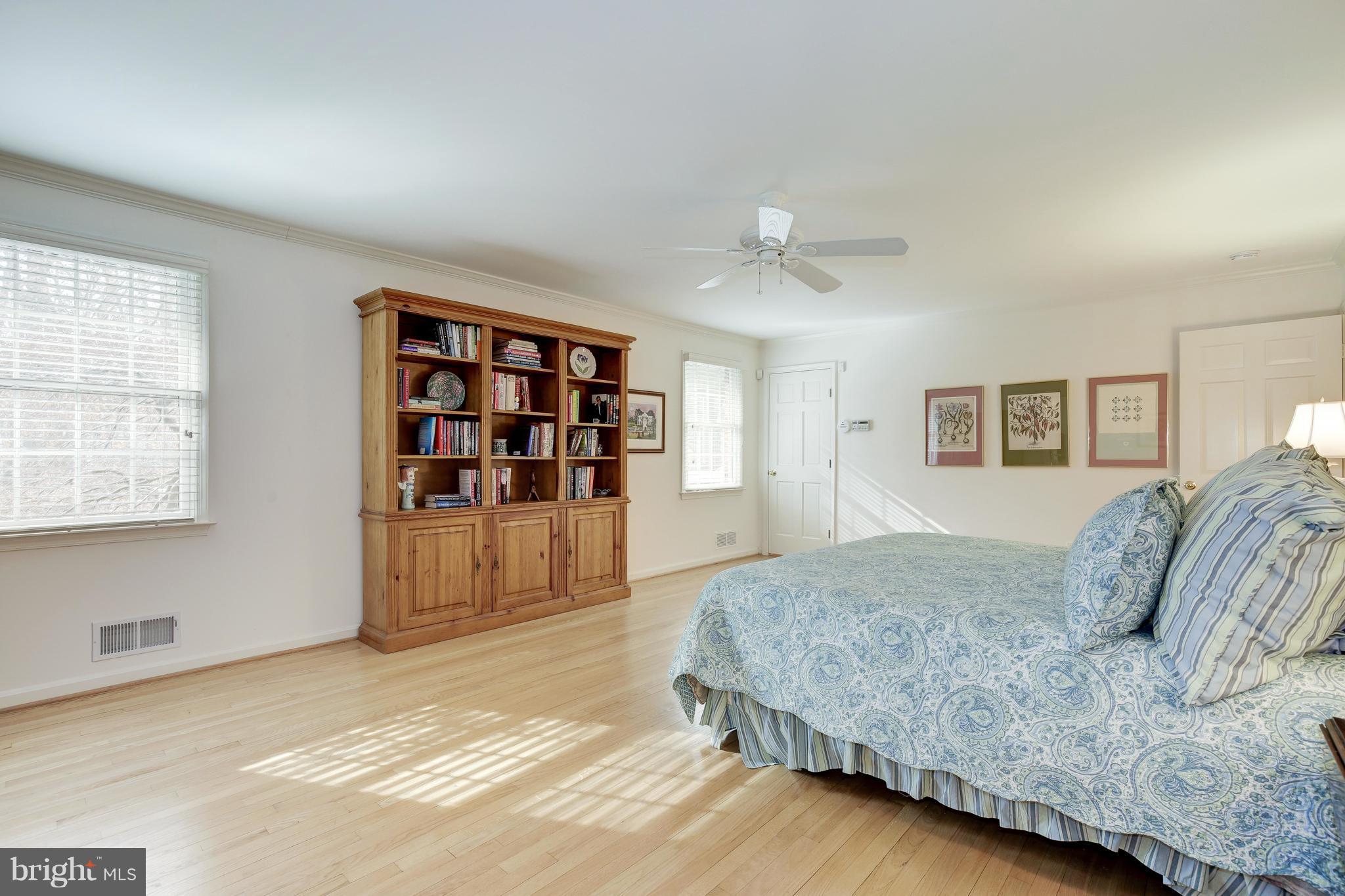 8821 Belmart Road Potomac, MD 20854 - Photo 15 of 29 a spacious bedroom with a large bed and a window