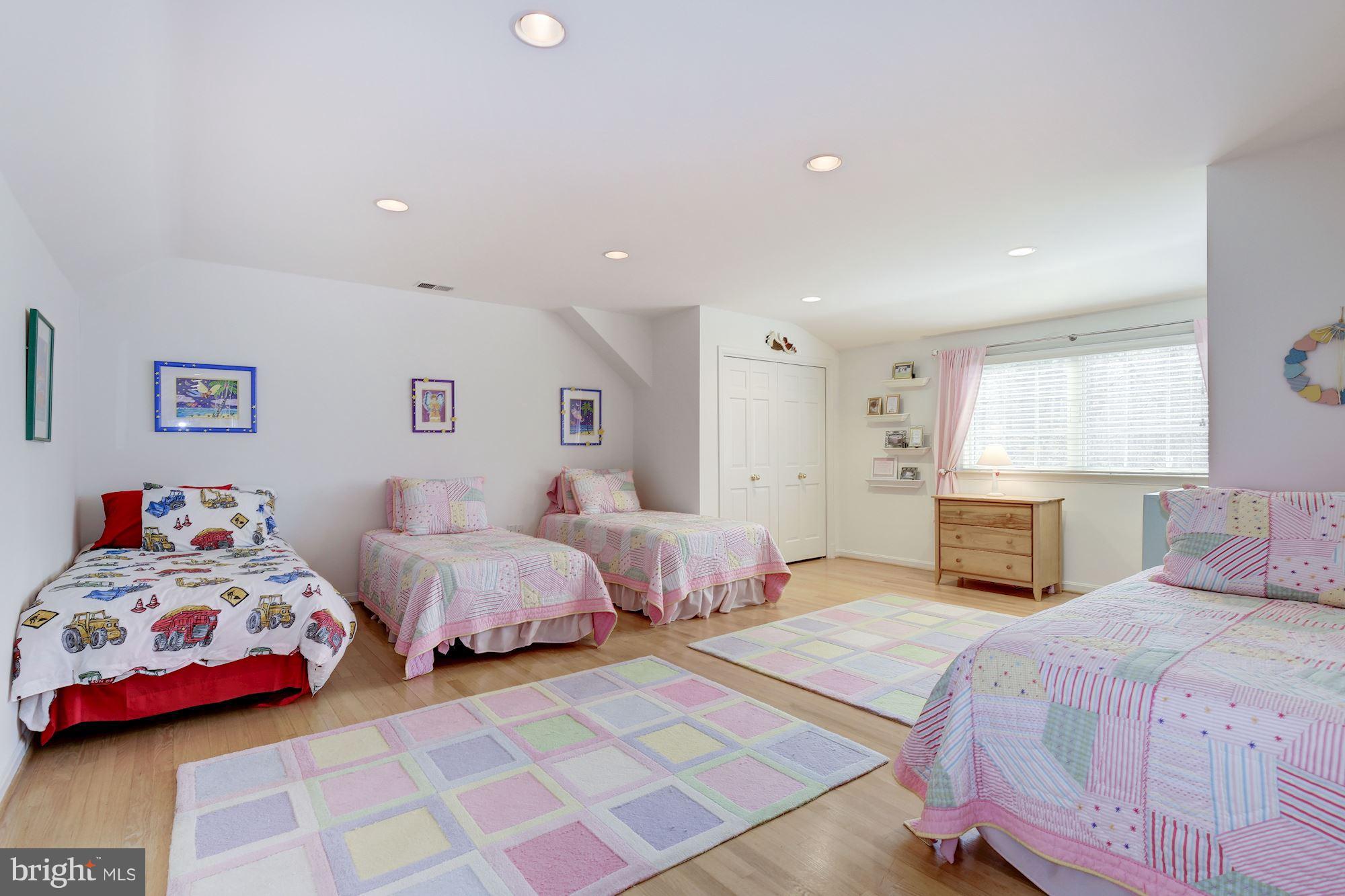 8821 Belmart Road Potomac, MD 20854 - Photo 21 of 29 a bedroom with two beds and a chandelier