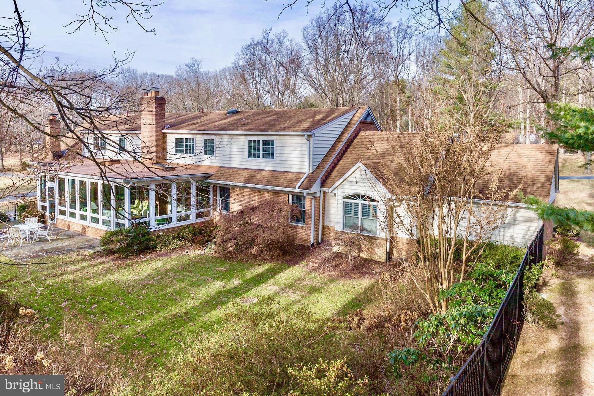 8821 Belmart Road Potomac, MD 20854 - Photo 26 of 29 a front view of a house with a yard table and chairs
