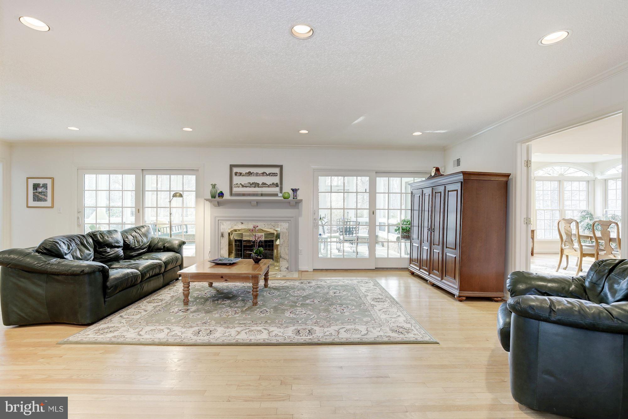 8821 Belmart Road Potomac, MD 20854 - Photo 8 of 29 a living room with furniture window and a fireplace