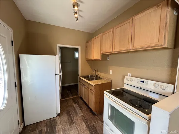 a kitchen with a stove sink and refrigerator