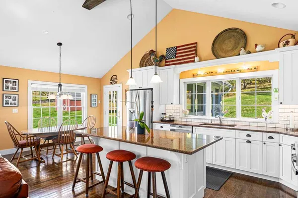 a view of a dining room with furniture a chandelier and wooden floor