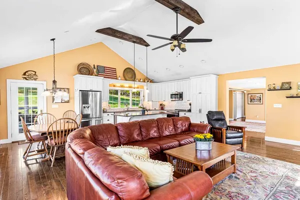 a living room with furniture ceiling fan and a window
