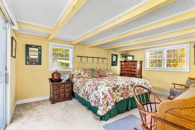 a bedroom with bed and wooden floor