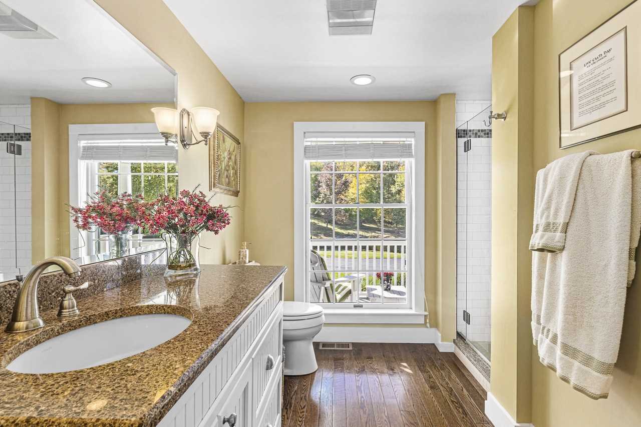 368 Skiba Road Gallatin, NY 12523 - Photo 18 of 40 a bathroom with a granite countertop sink a mirror and a shower