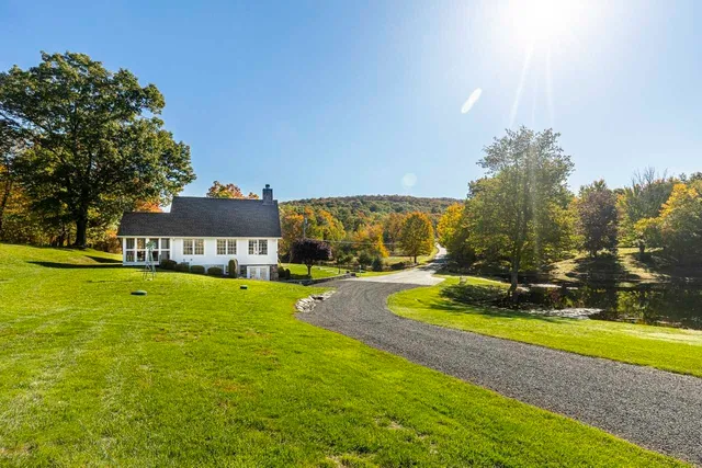 a view of a house with swimming pool and yard