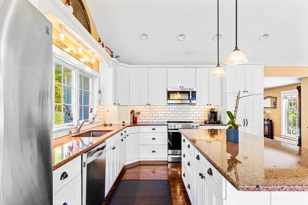 a kitchen with a sink a stove and cabinets