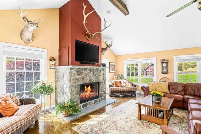 a living room with furniture a flat screen tv and a fireplace
