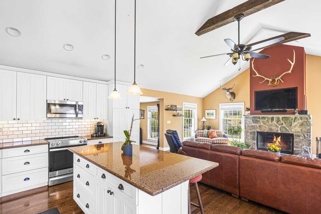 368 Skiba Road Gallatin, NY 12523 - Photo 9 of 40 a living room with stainless steel appliances kitchen island granite countertop furniture a fireplace and a chandelier