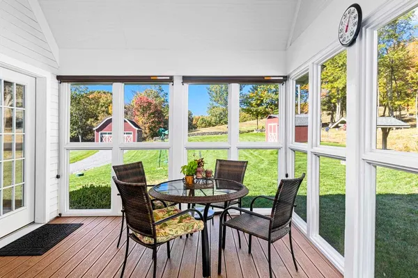 a view of a dining room with furniture large windows and wooden floor