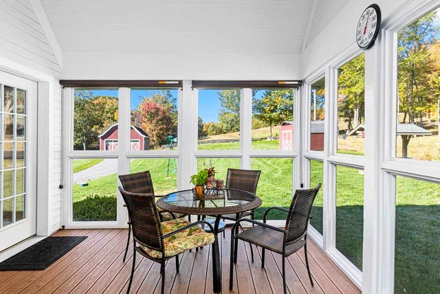 a view of a dining room with furniture large windows and wooden floor