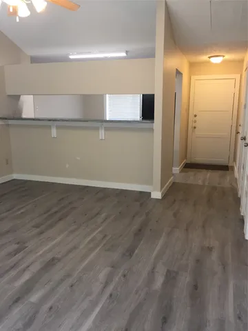 an empty room with wooden floor