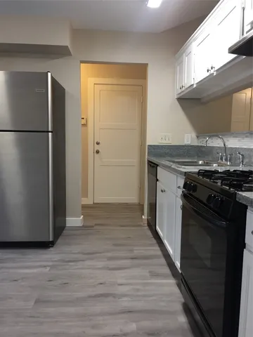 a kitchen with stainless steel appliances granite countertop a stove and a refrigerator
