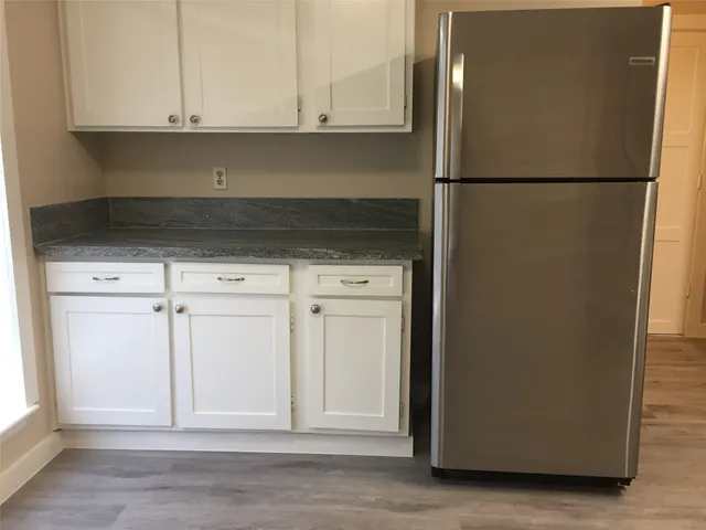 a view of a kitchen with a stove cabinets and wooden floor