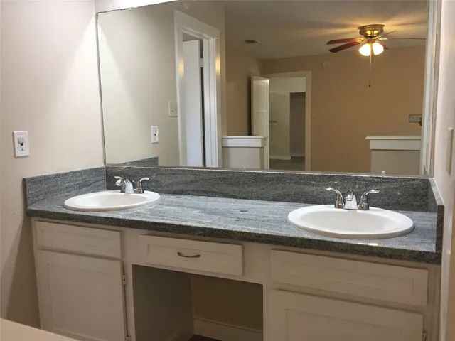 a white bath tub sitting next to a toilet