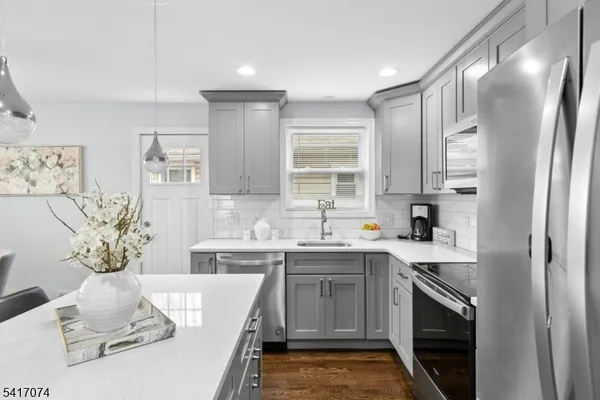 a kitchen with a sink stove and refrigerator