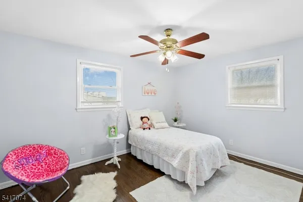 a bedroom with a bed dresser and a window