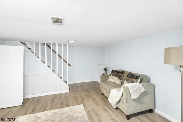 a view of a hallway with white couches and pillows