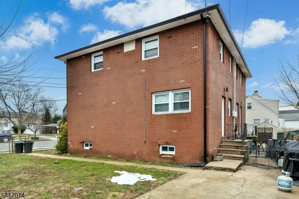 a backyard of a house with oven and a tree