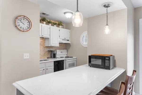 a kitchen with a table chairs and a stove