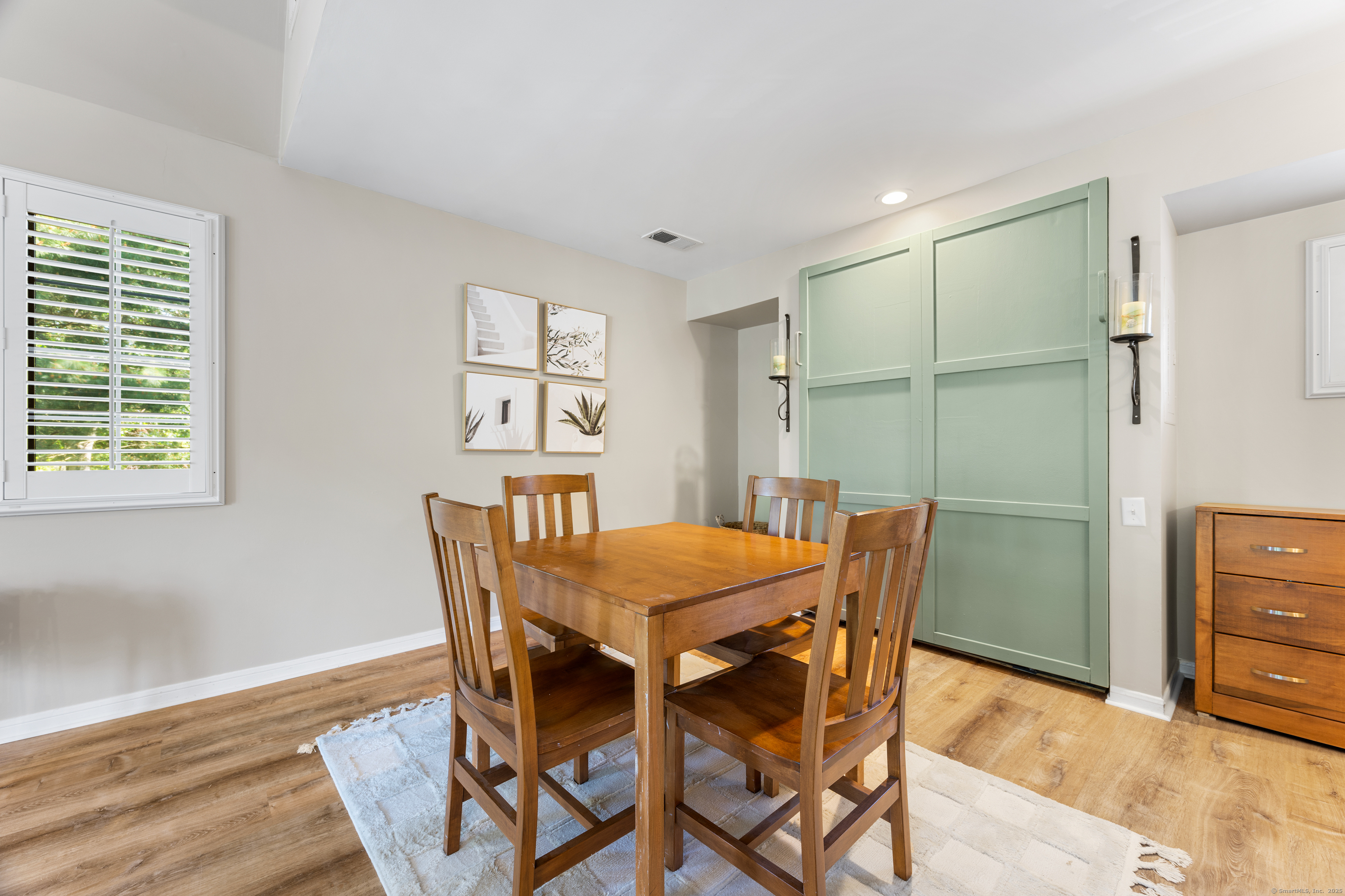 2124 Old Pond Lane, Unit 2124 Norwich, CT 06360 - Photo 11 of 30 a view of a dining room with furniture and wooden floor