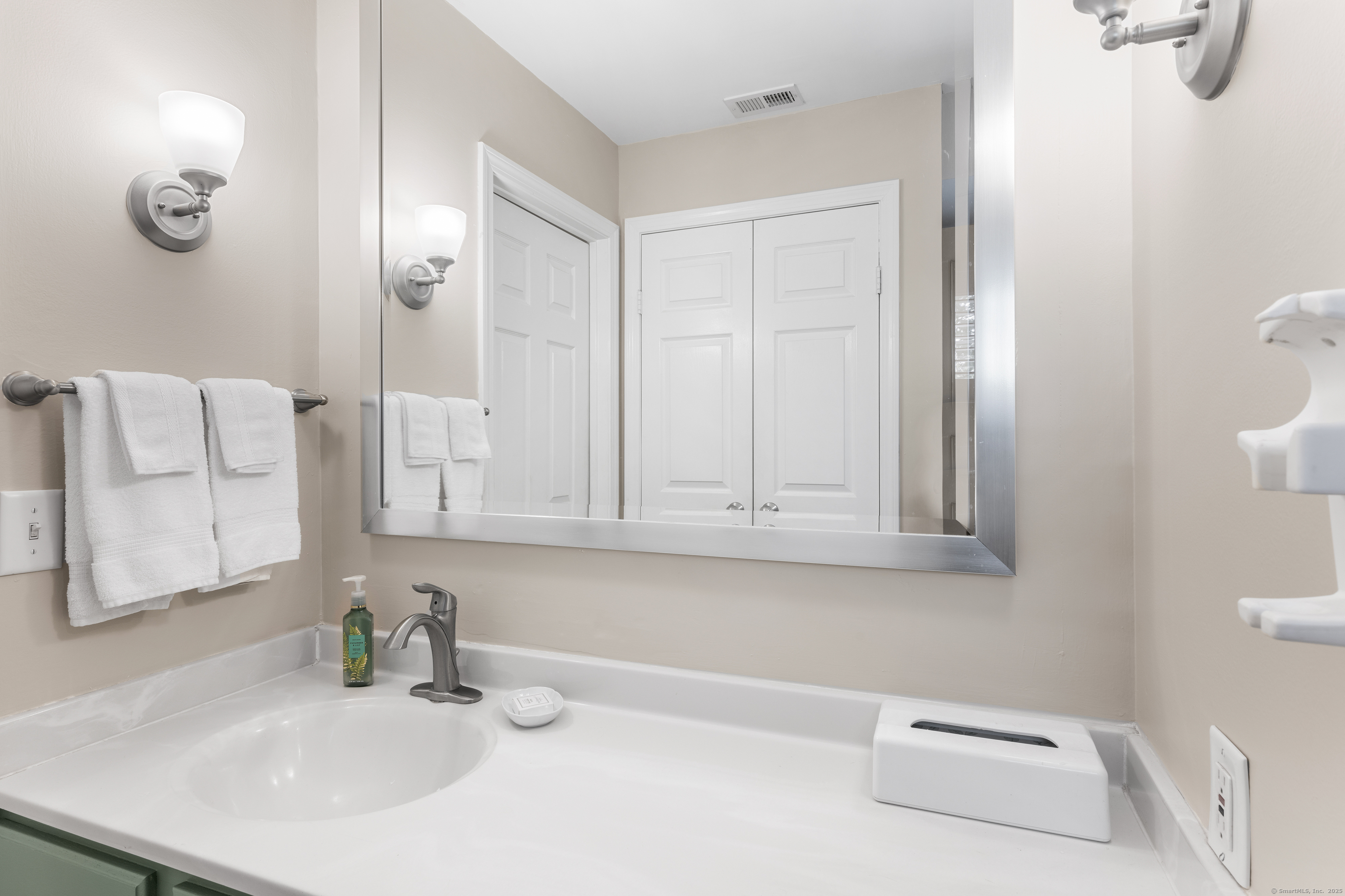 2124 Old Pond Lane, Unit 2124 Norwich, CT 06360 - Photo 13 of 30 a bathroom with a sink and a mirror