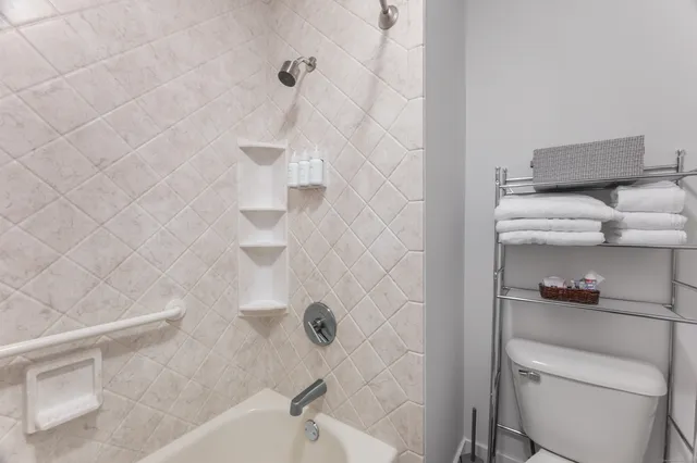 a bathroom with a toilet and a shower