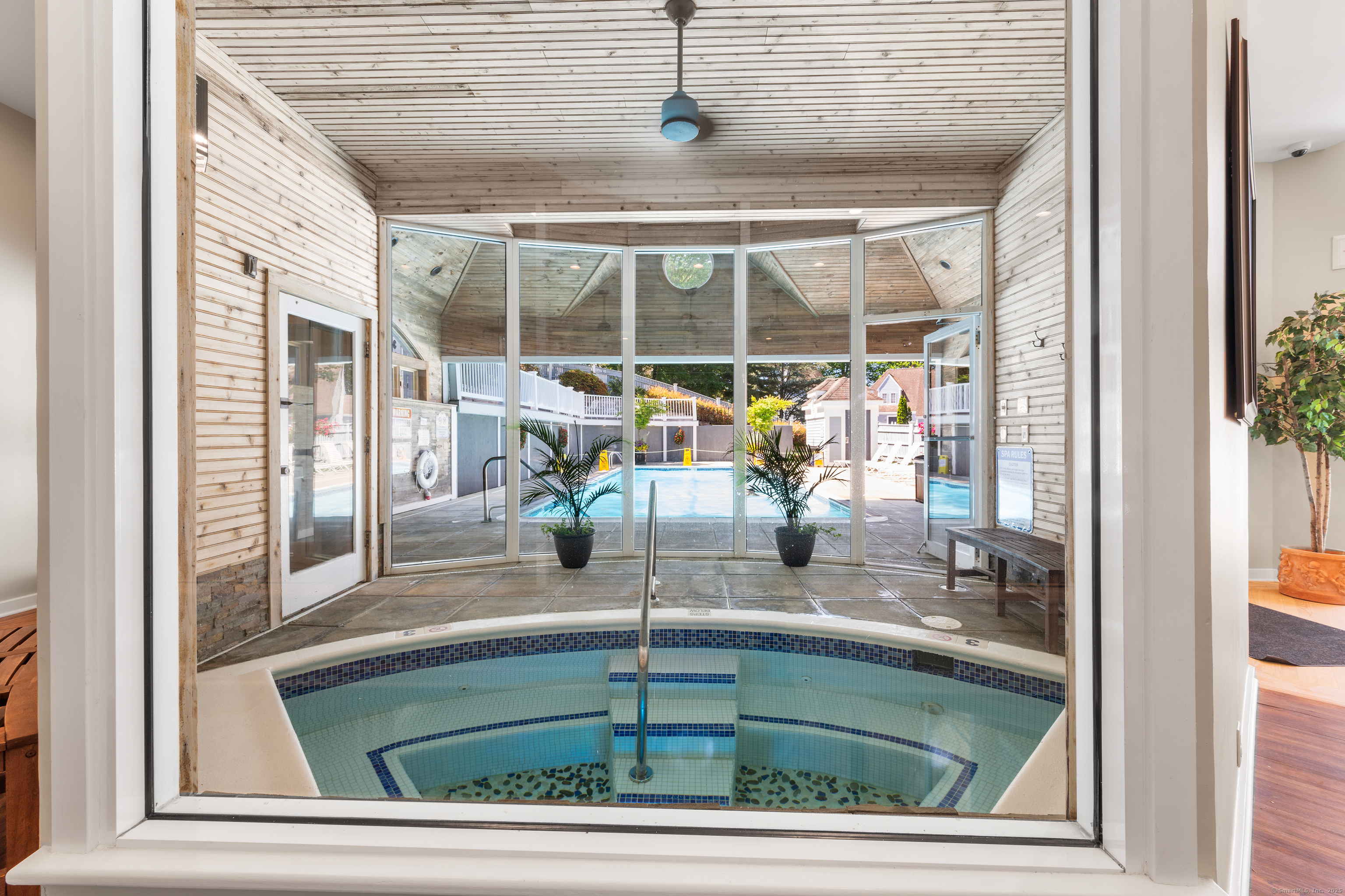 2124 Old Pond Lane, Unit 2124 Norwich, CT 06360 - Photo 27 of 30 a room with a floor to ceiling window and pool