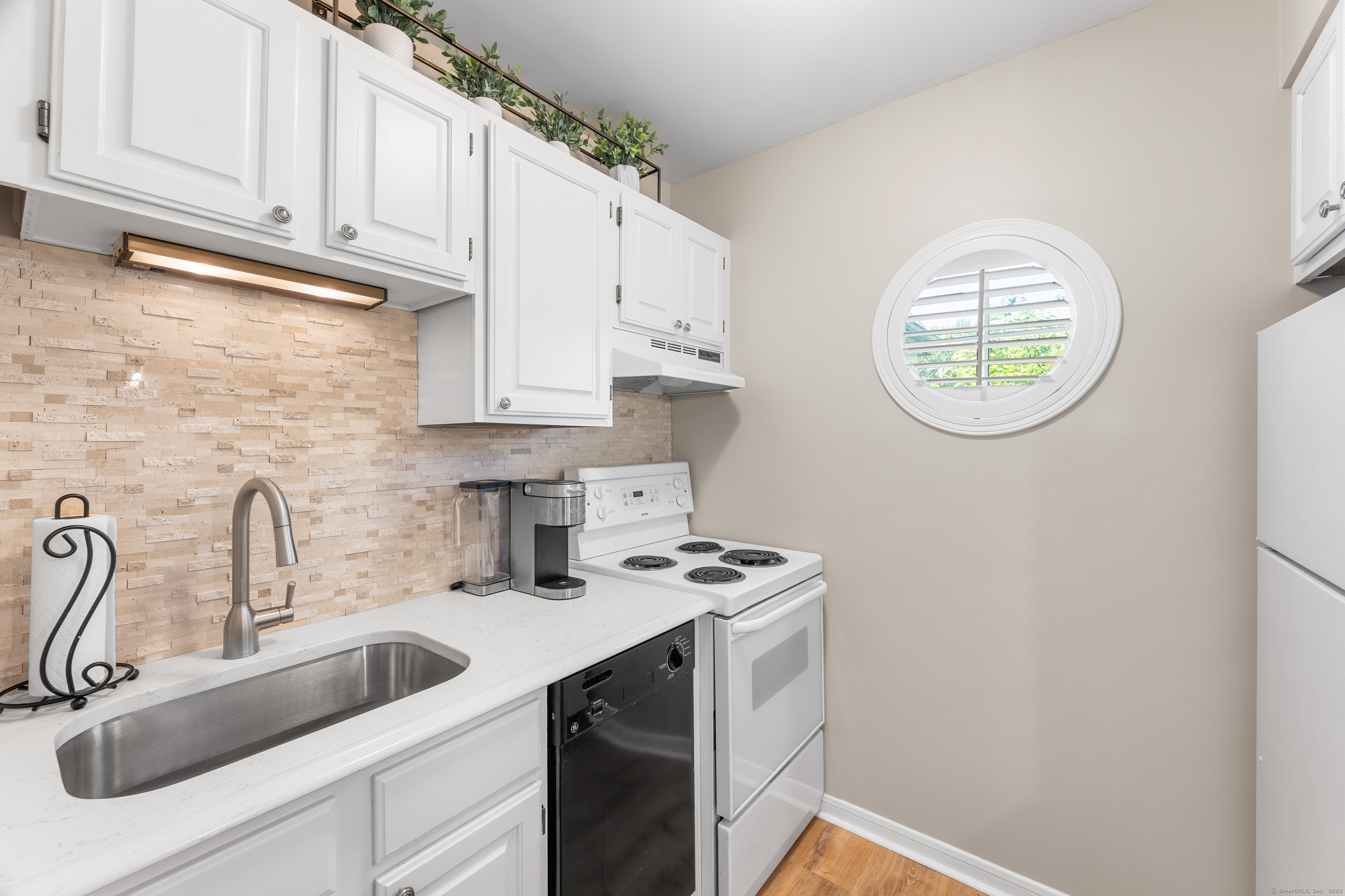 2124 Old Pond Lane, Unit 2124 Norwich, CT 06360 - Photo 4 of 30 a kitchen with stainless steel appliances granite countertop a sink a stove and cabinets