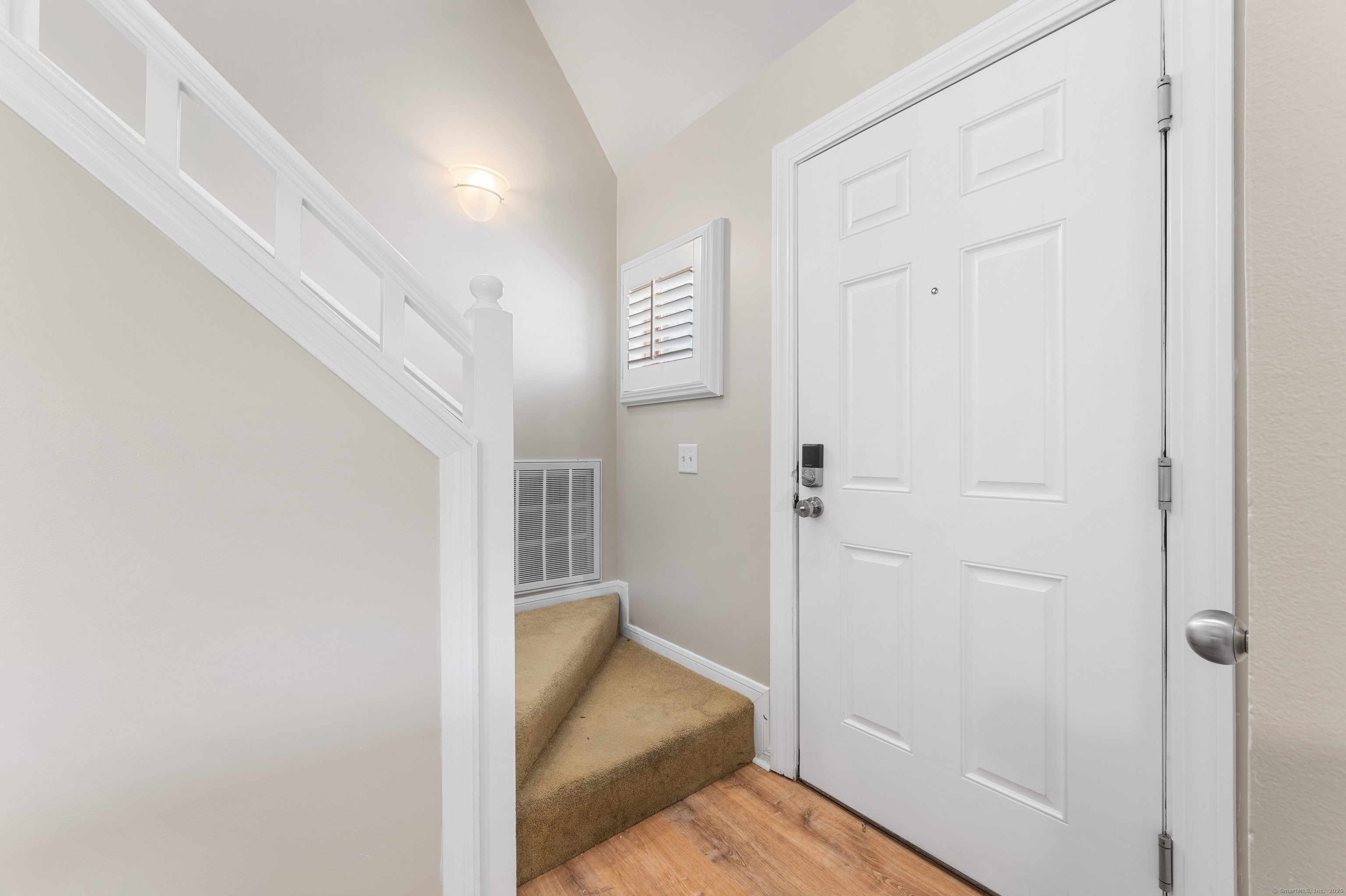 2124 Old Pond Lane, Unit 2124 Norwich, CT 06360 - Photo 6 of 30 a view of a hallway with wooden floor and closet