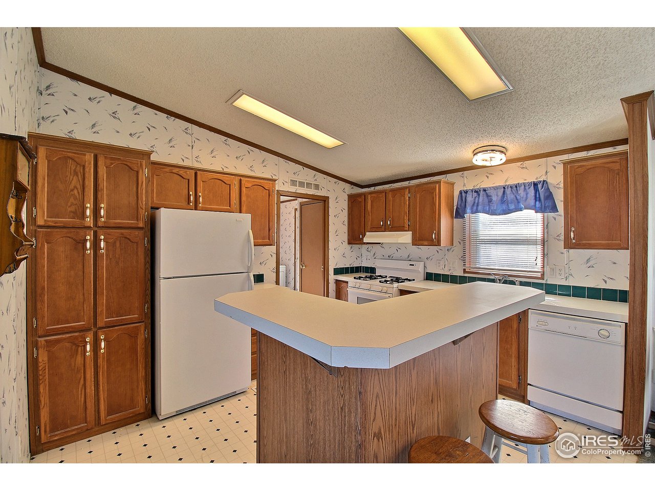 3380 West 3rd Street Road Greeley, CO 80631 - Photo 12 of 34 Pantry and Kitchen Island