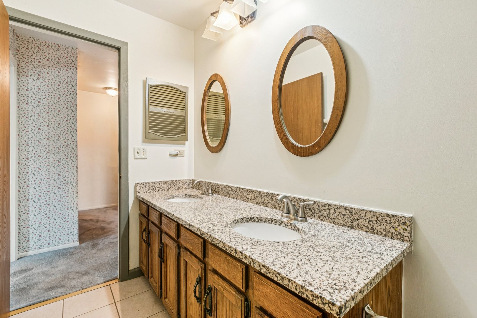 18604 Carpenter Street Homewood, IL 60430 - Photo 17 of 31 a bathroom with a granite countertop sink and a mirror