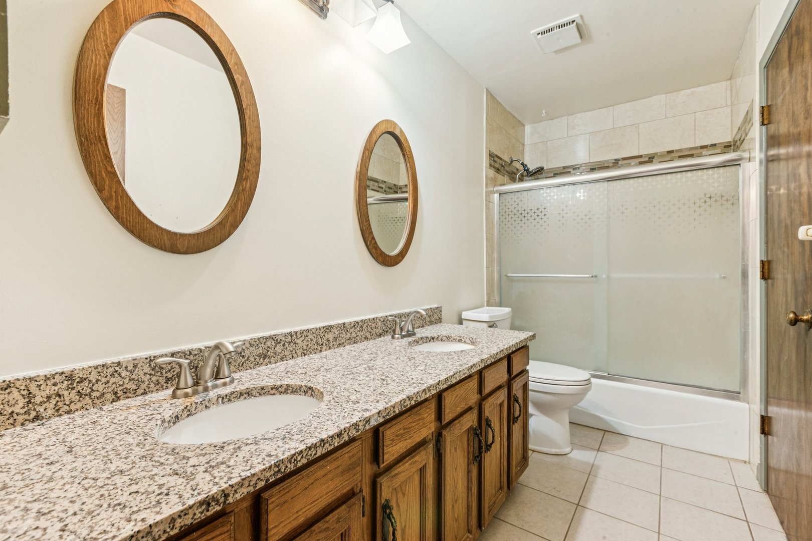18604 Carpenter Street Homewood, IL 60430 - Photo 18 of 31 a bathroom with a granite countertop double vanity sink and a mirror
