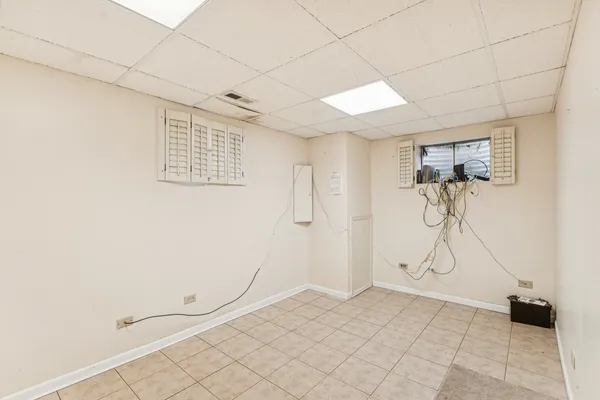 a view of a house with a big yard and large trees
